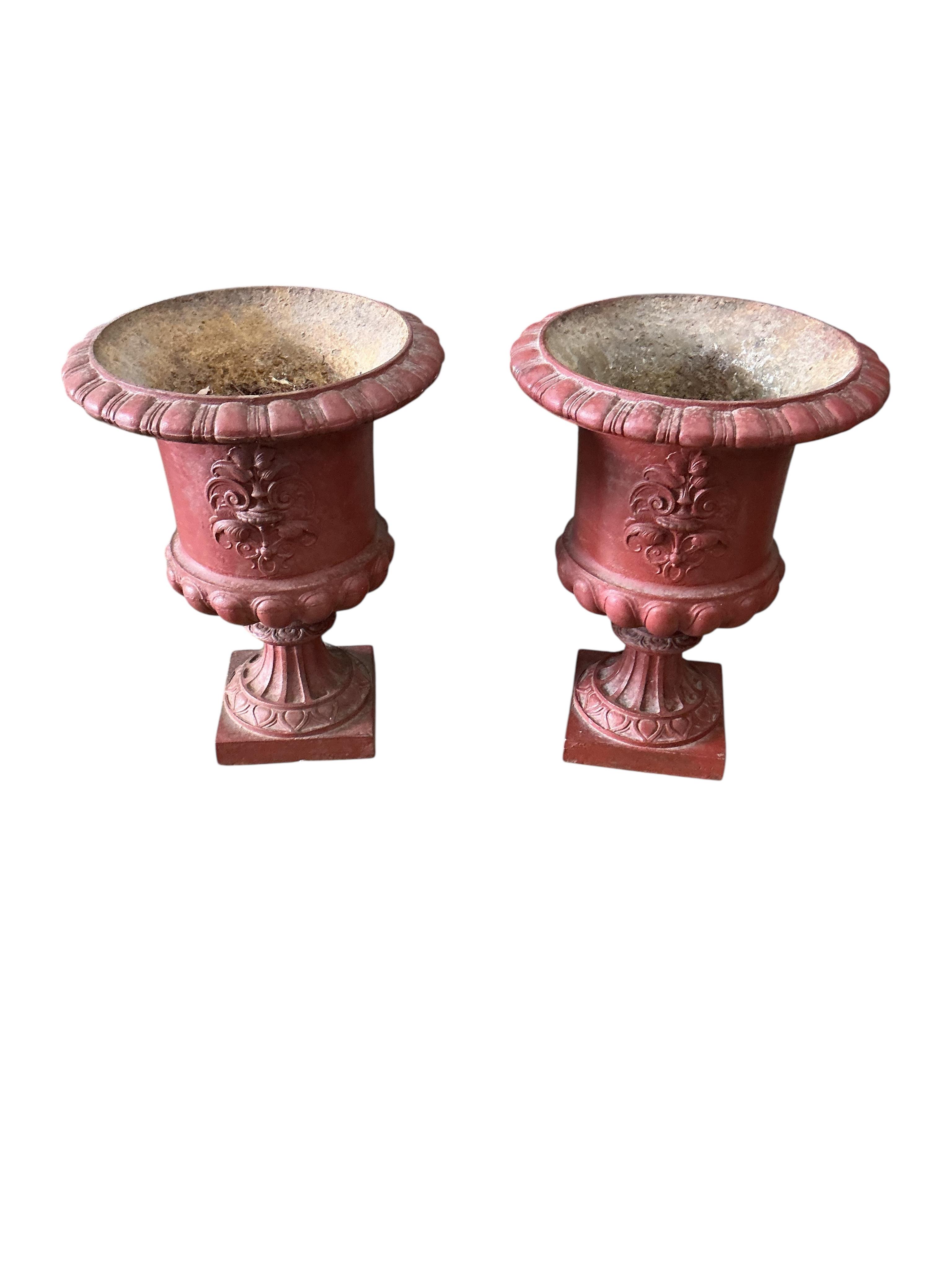 Two pairs of Victorian style cast iron campana urns, larger diameter 30cm, height 41cm, Provenance: The late Kenneth Turner (1936-2025), celebrity florist, designer and perfume retailer, he received the Royal Warrant fro